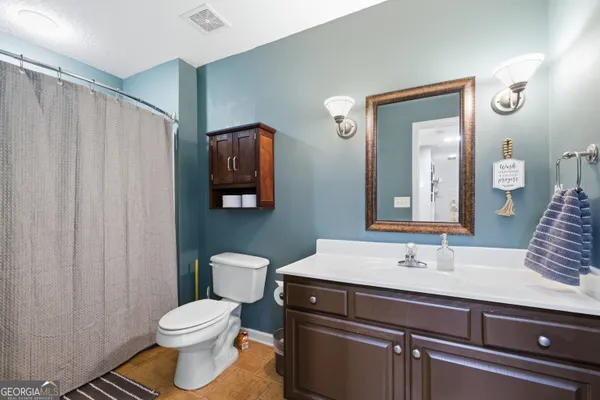 a bathroom with a sink a toilet and mirror