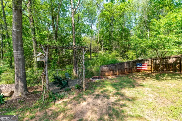 a backyard of a house with lots of green space and plants