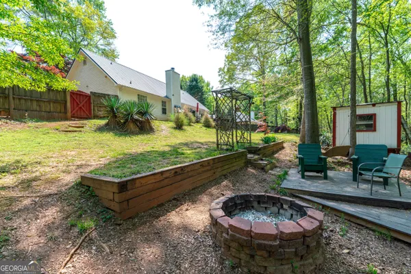 a back yard with a table and a fire pit