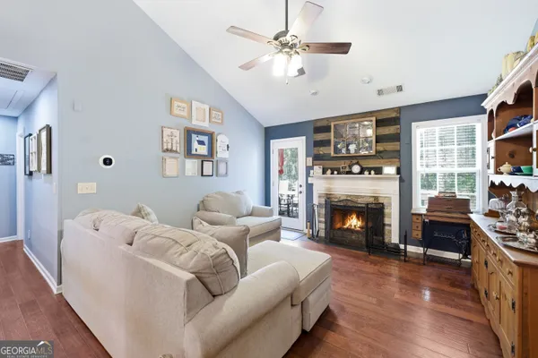 a living room with furniture fireplace and window