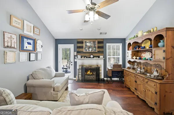 a living room with furniture fireplace and flat screen tv