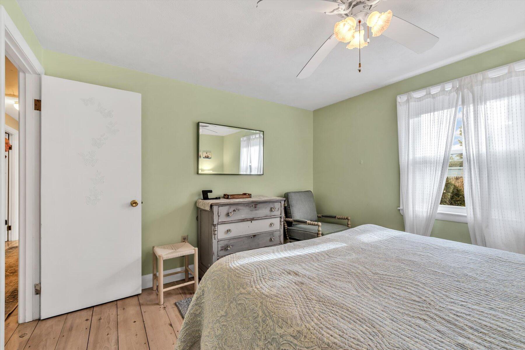 19 Pine Rock Road East Falmouth, MA 02536 - Photo 24 of 52 a bedroom with a bed and a chandelier