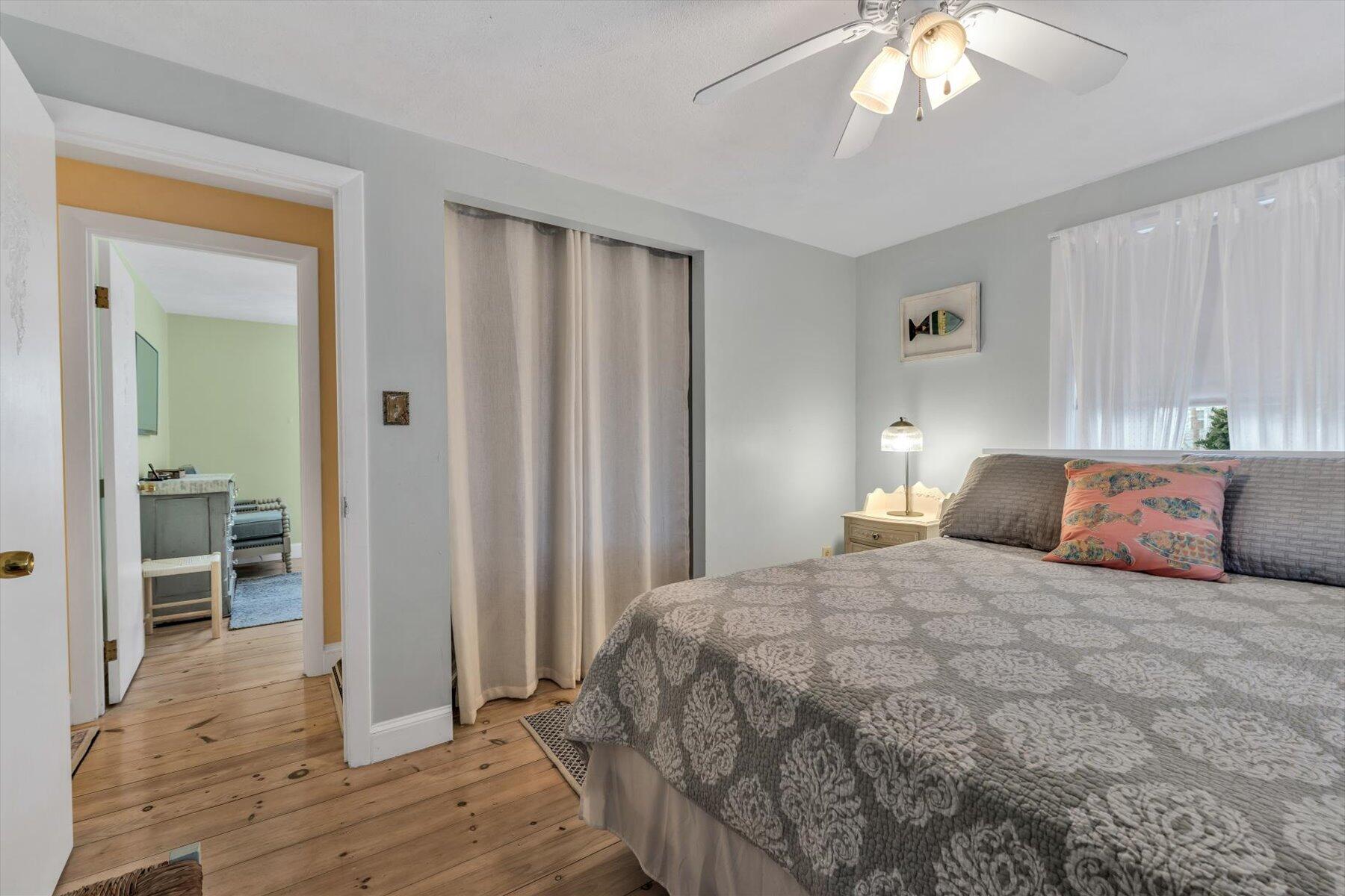 19 Pine Rock Road East Falmouth, MA 02536 - Photo 28 of 52 a bedroom with a large bed and a chandelier