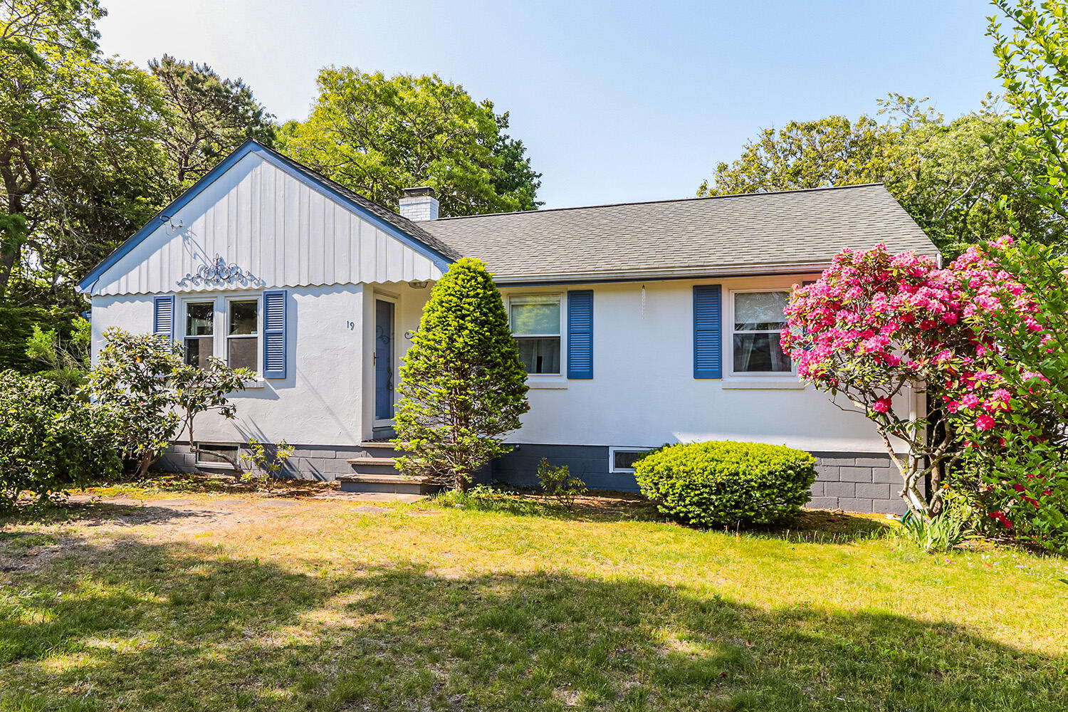 19 Pine Rock Road East Falmouth, MA 02536 - Photo 4 of 52 a front view of house with yard and trees in the background