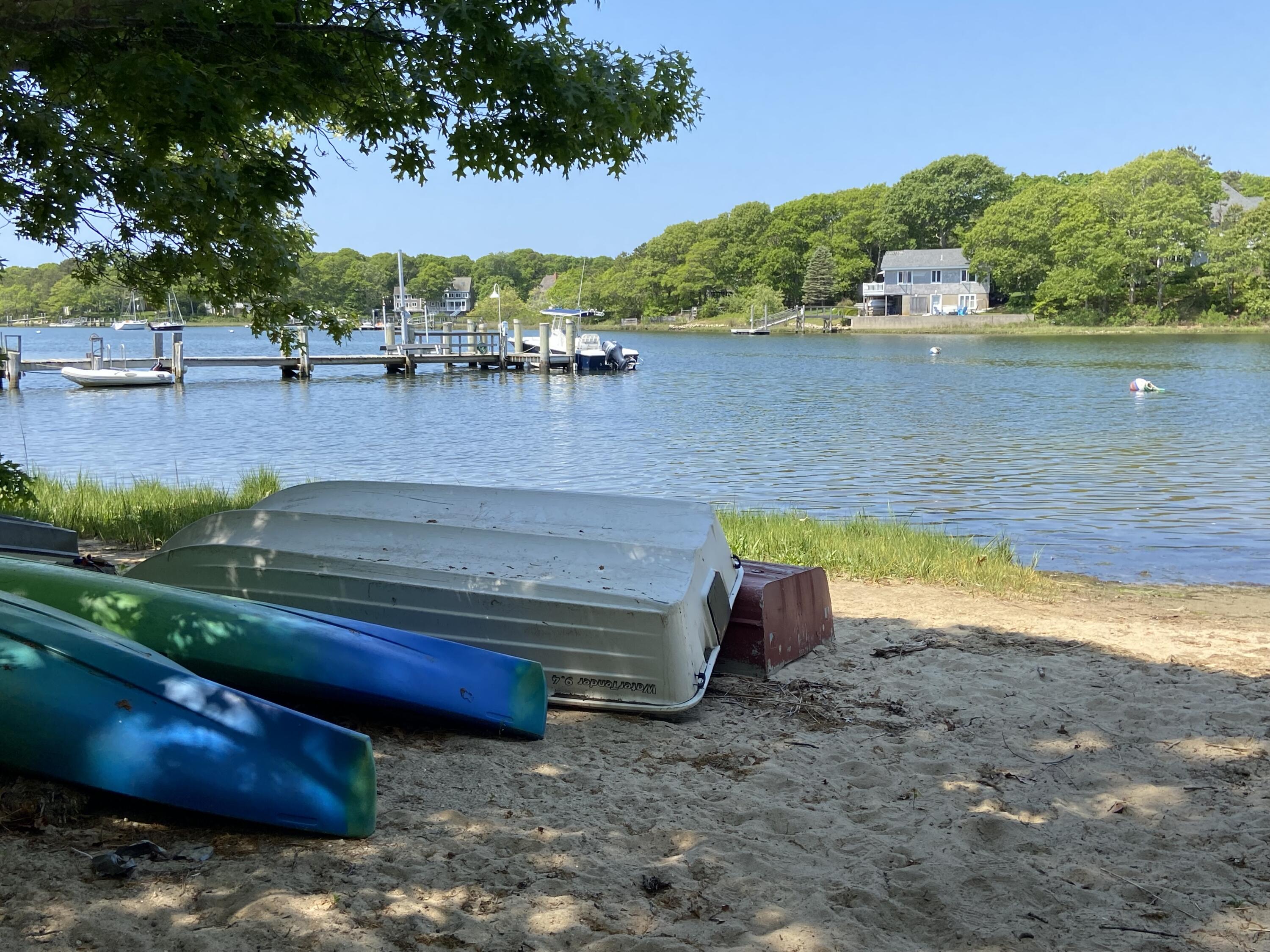 19 Pine Rock Road East Falmouth, MA 02536 - Photo 5 of 52 a view of a lake with a yard and a large tree