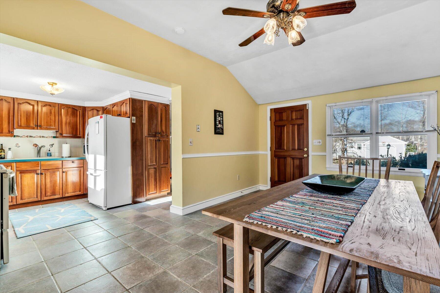 19 Pine Rock Road East Falmouth, MA 02536 - Photo 8 of 52 a view of a kitchen with kitchen island stainless steel appliances wooden floor dining table and chairs