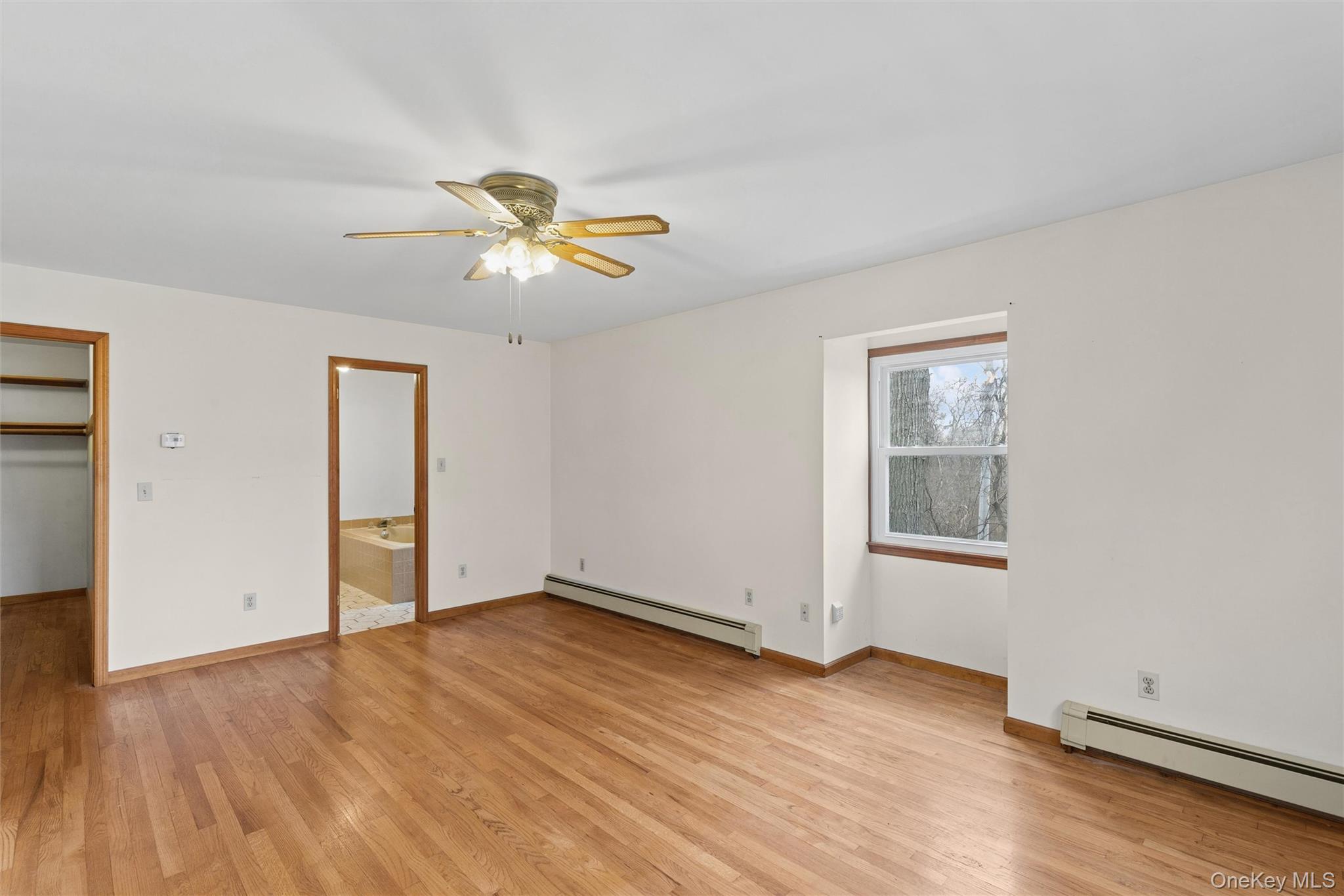 49 Overhill Road Wading River, NY 11792 - Photo 14 of 27 an empty room with wooden floor and windows