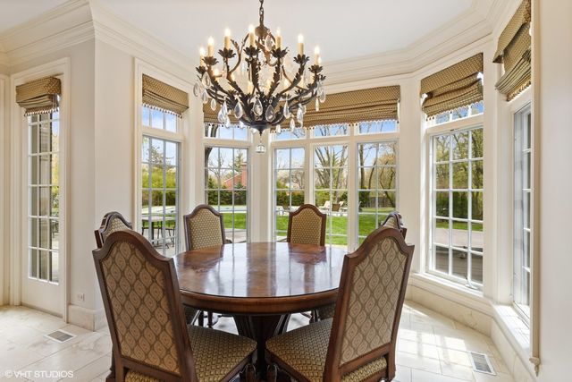 a living room with furniture a fireplace a large window and a large window
