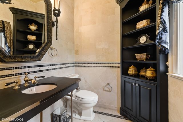 a view of a hallway with a glass door and a bathroom