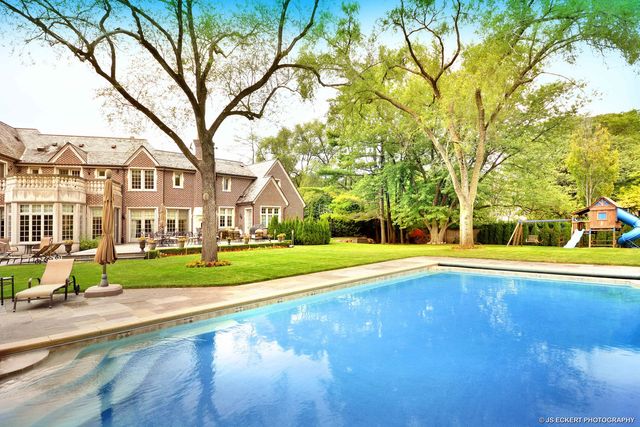 a view of yard with swimming pool and green space