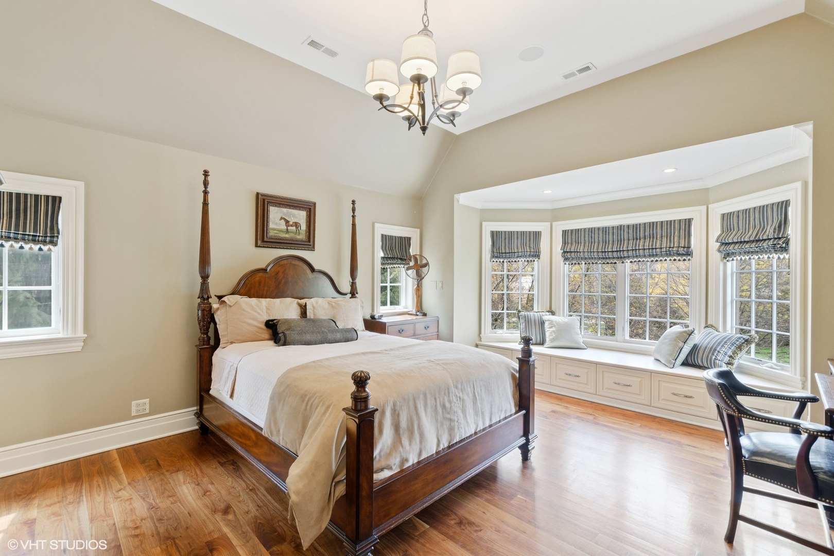 1451 North Green Bay Road Lake Forest, IL 60045 - Photo 25 of 55 a bedroom with a large bed and a chandelier