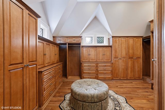 a bathroom with a tub a sink and a large mirror
