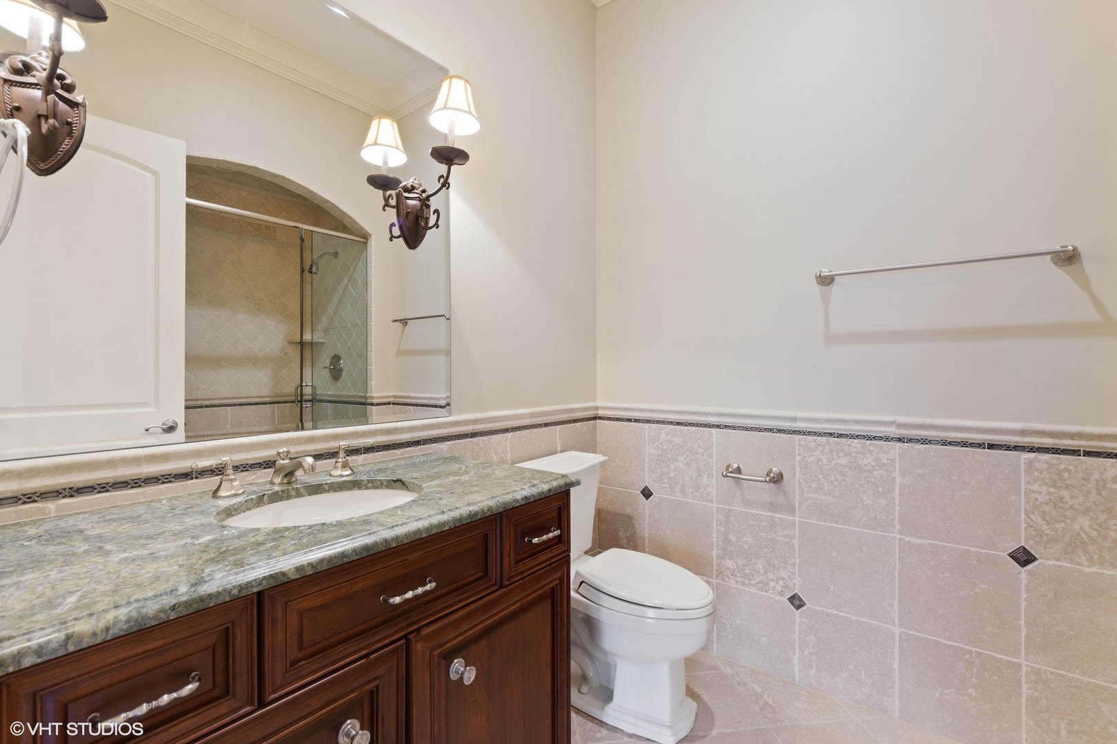 1451 North Green Bay Road Lake Forest, IL 60045 - Photo 40 of 55 a bathroom with a granite countertop sink a toilet and a mirror