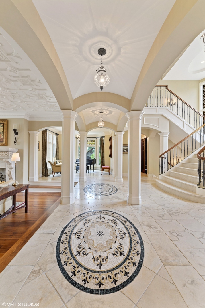 1451 North Green Bay Road Lake Forest, IL 60045 - Photo 6 of 55 a view of a hallway with a dining table and chandelier