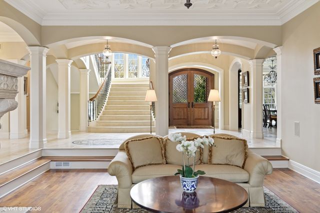 a living room with furniture a piano and a window