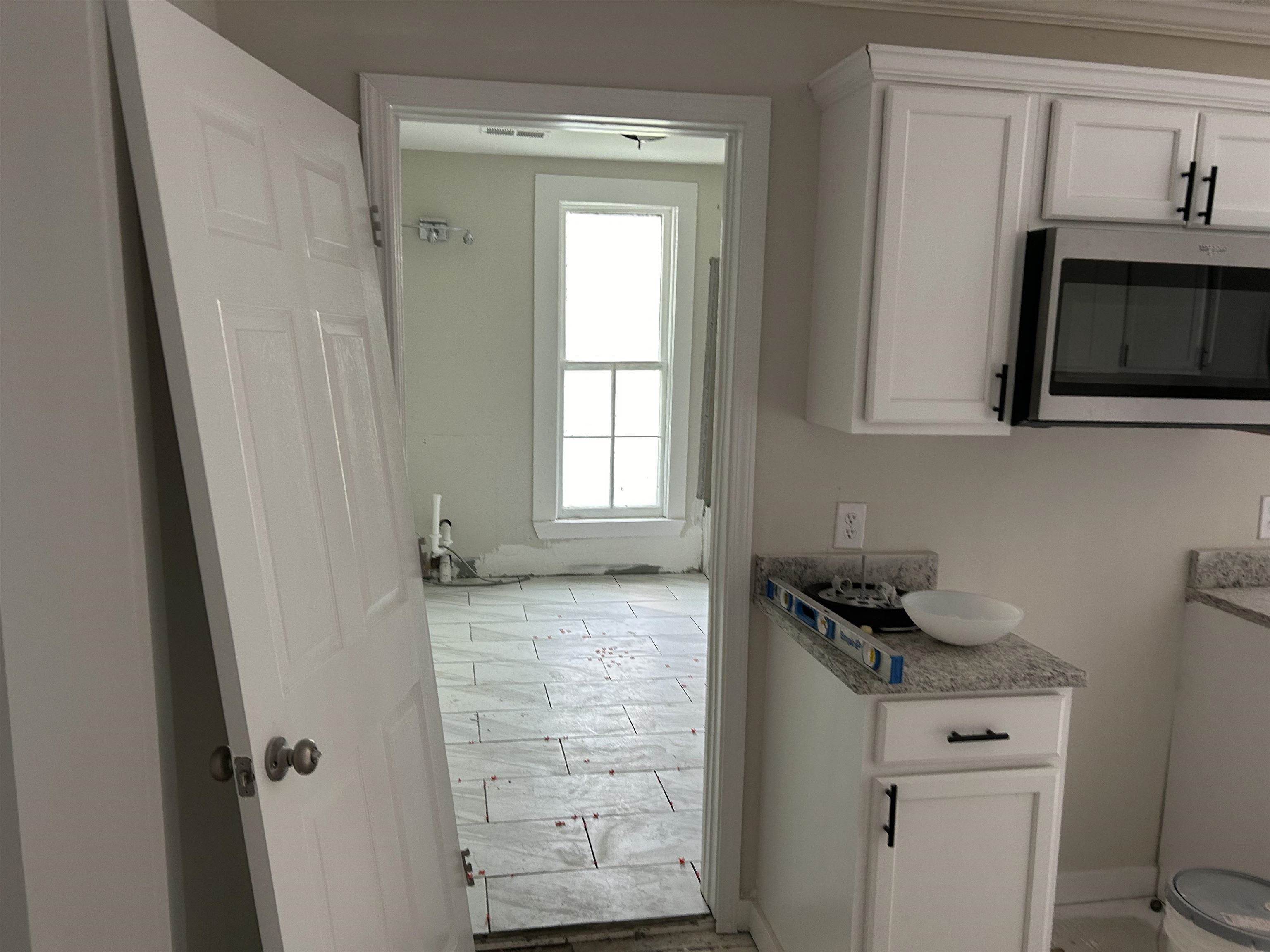 605 Byars Street Covington, TN 38019 - Photo 9 of 11 a bathroom with a granite countertop sink and a mirror