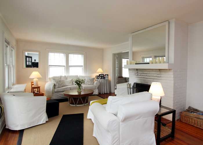 83 Strickland Road, Unit A Cos Cob, CT 06807 - Photo 3 of 8 a living room with furniture fireplace and a large window