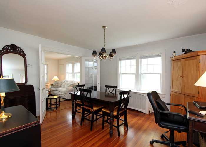 83 Strickland Road, Unit A Cos Cob, CT 06807 - Photo 4 of 8 a view of a a dining room with furniture window and wooden floor