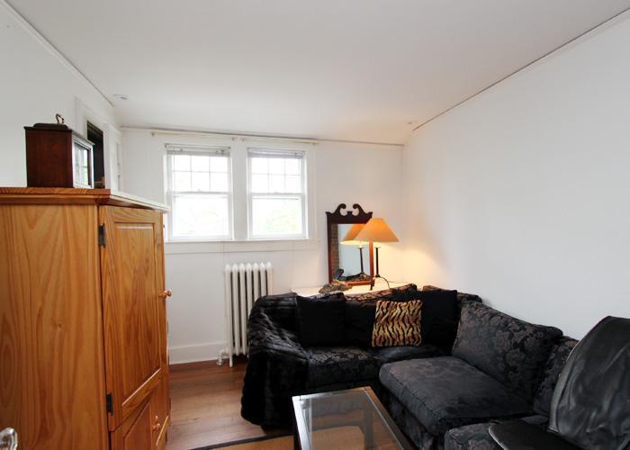 83 Strickland Road, Unit A Cos Cob, CT 06807 - Photo 8 of 8 a living room with furniture a window and a flat screen tv