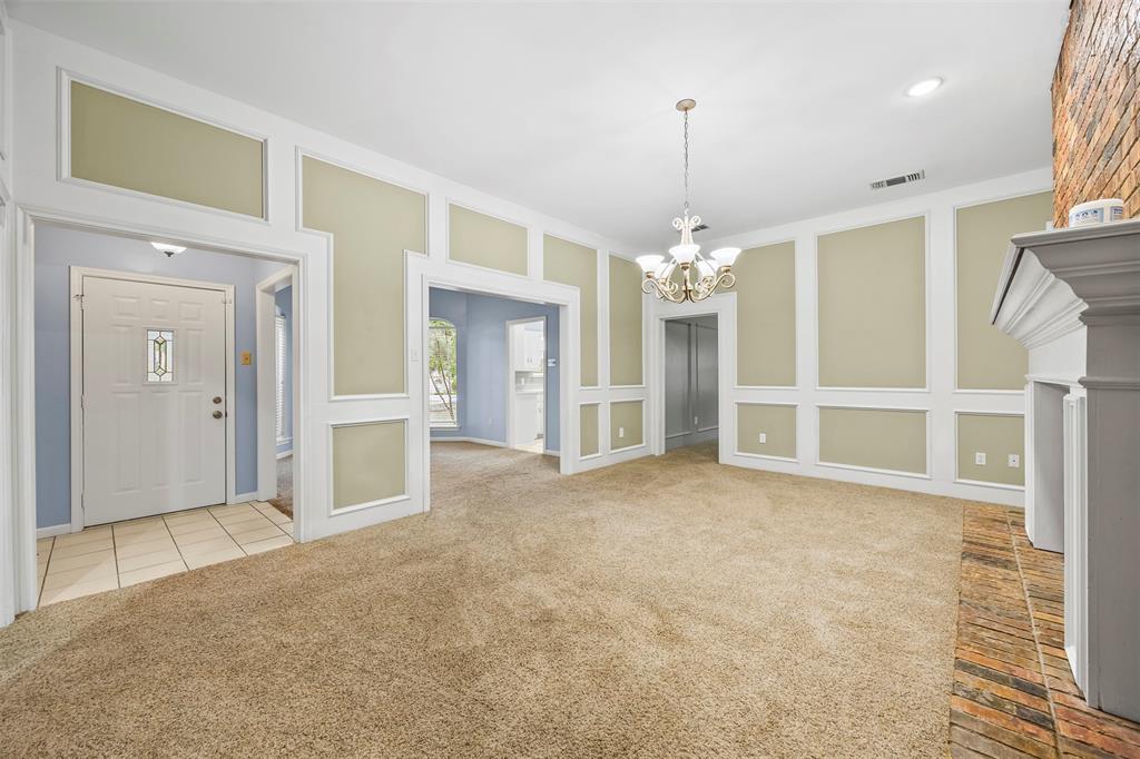 909 Valley View Avenue Red Oak, TX 75154 - Photo 8 of 37 a view of a livingroom with a chandelier fan and kitchen view