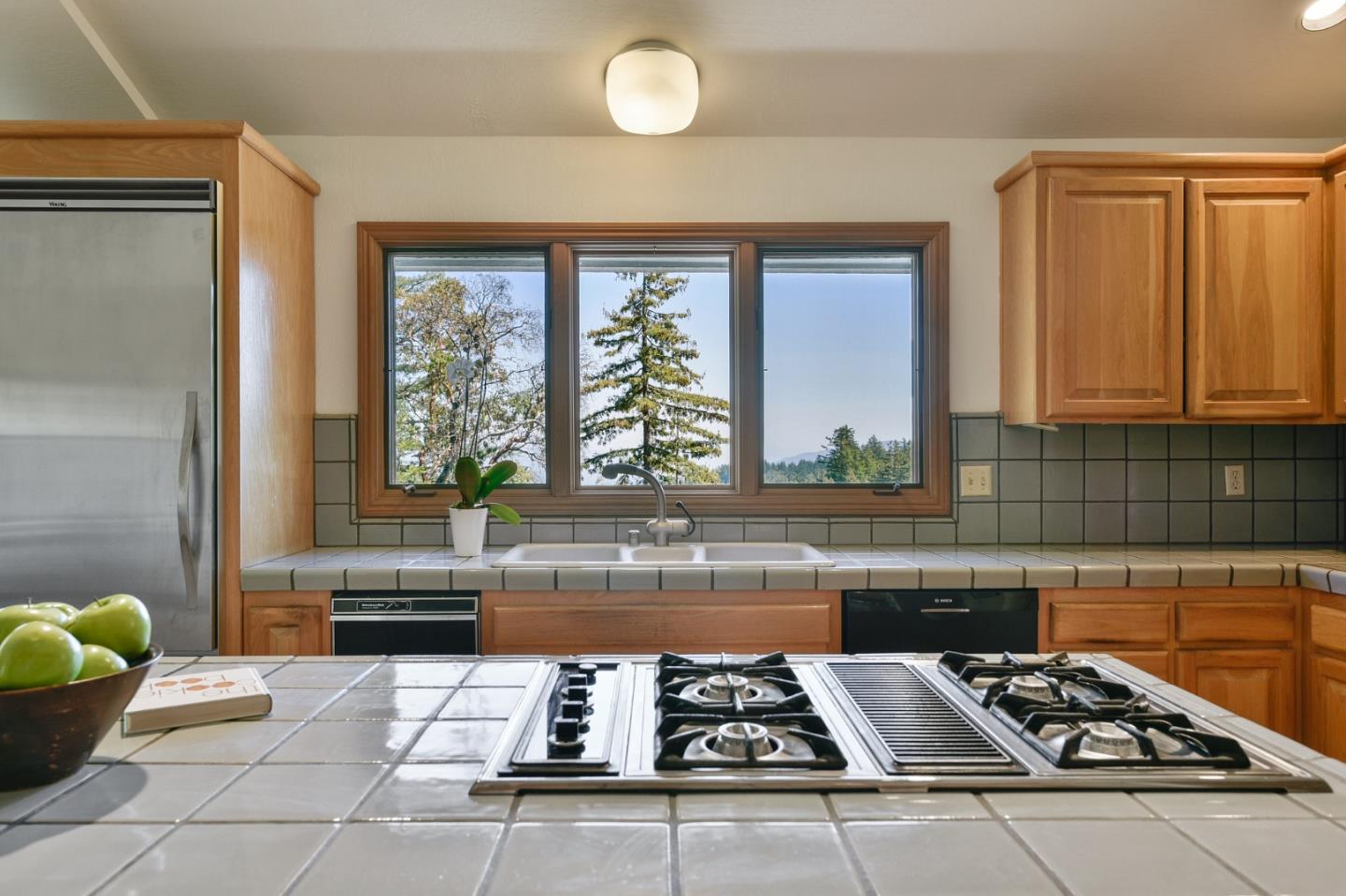 255 Allen Road Woodside, CA 94062 - Photo 11 of 43 a kitchen with a stove a sink cabinetry and a window