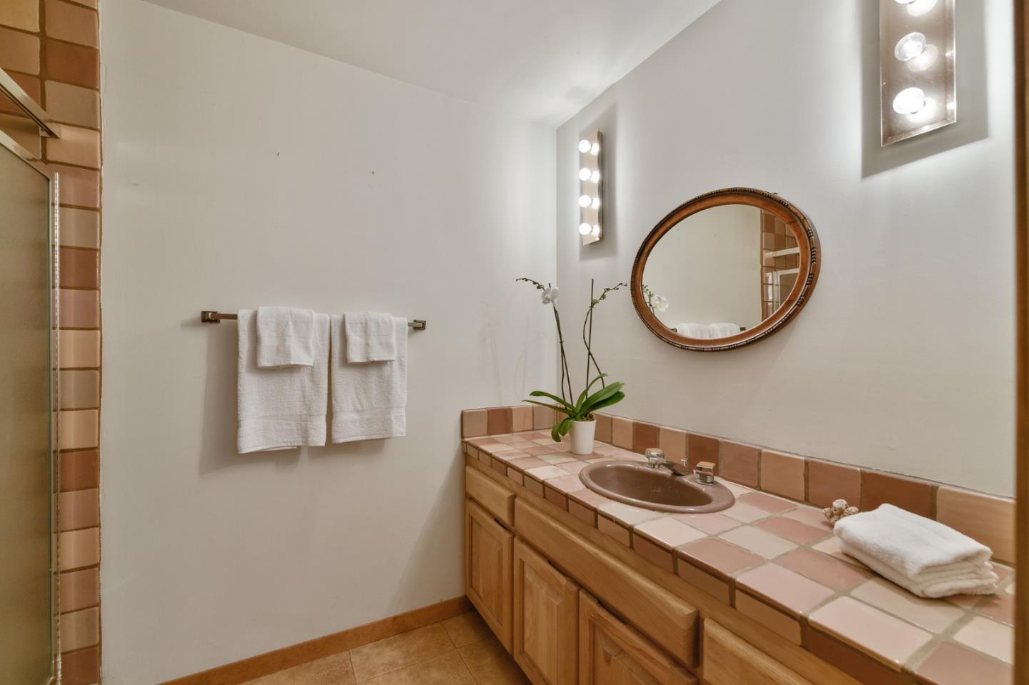 255 Allen Road Woodside, CA 94062 - Photo 22 of 43 a bathroom with a granite countertop double vanity sink and a mirror