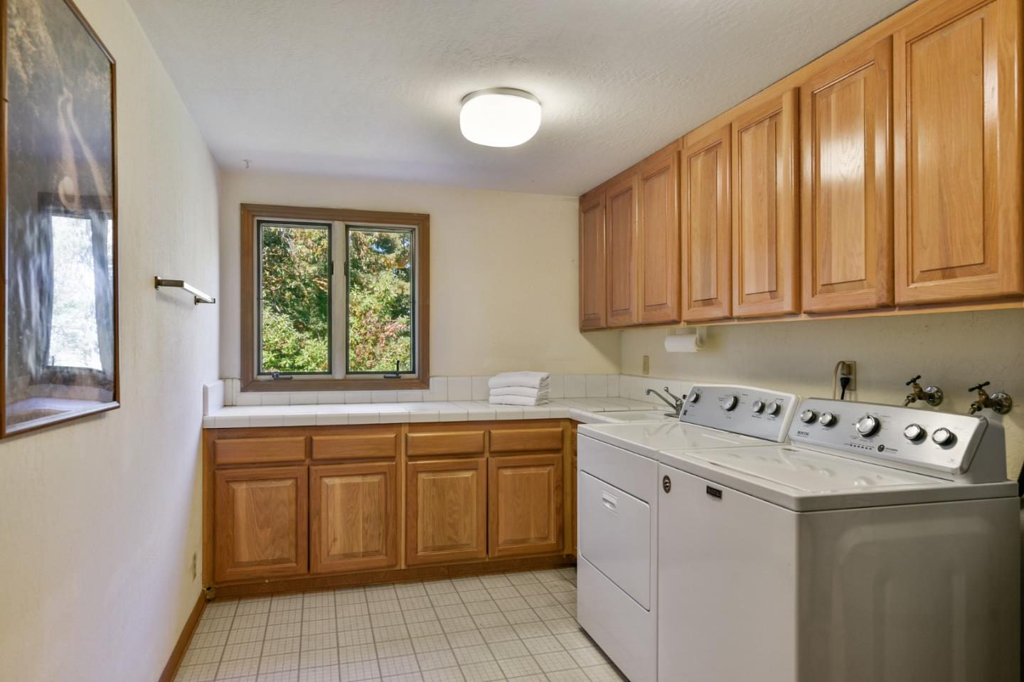 255 Allen Road Woodside, CA 94062 - Photo 27 of 43 a utility room with cabinets washer and dryer