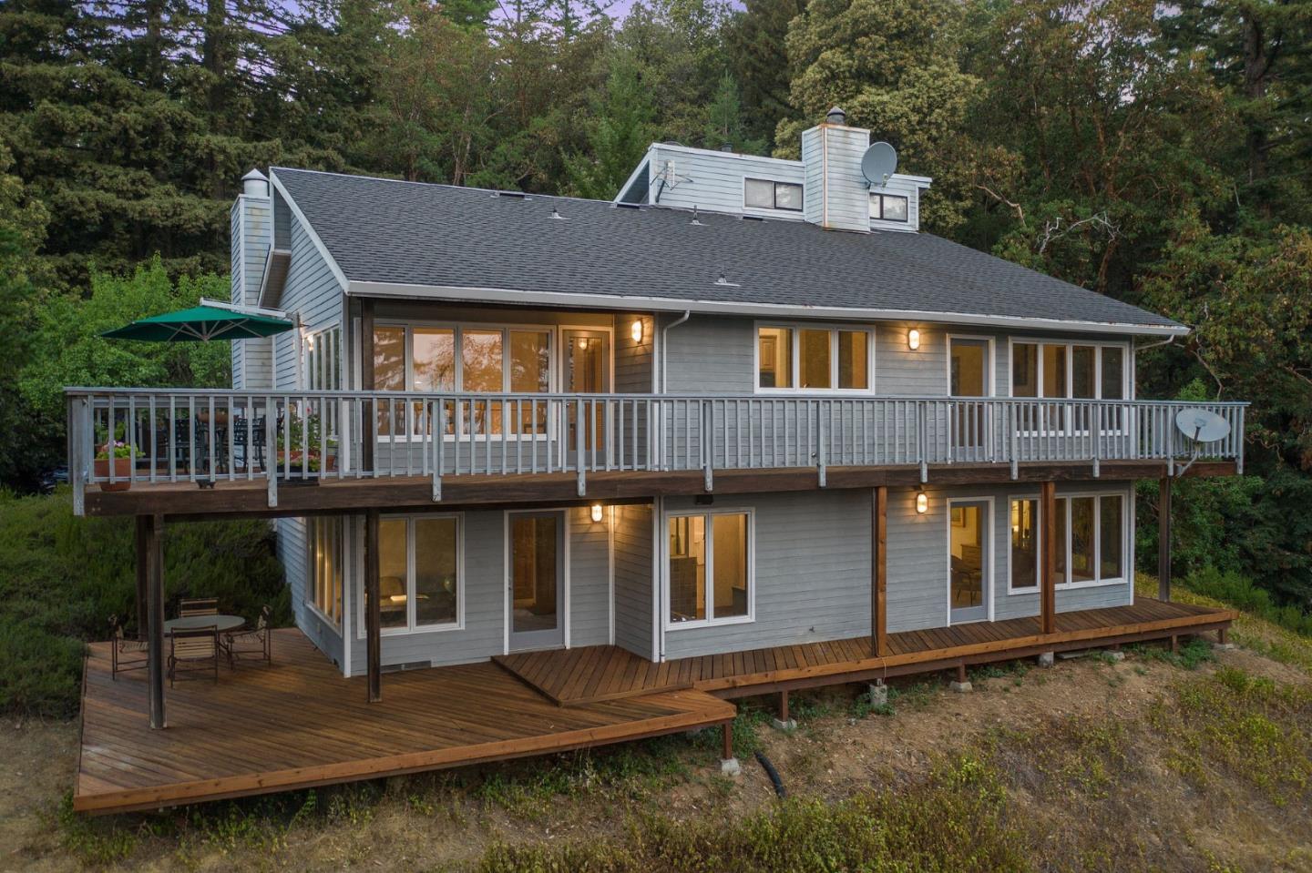 255 Allen Road Woodside, CA 94062 - Photo 37 of 43 a view of a white house with large windows and a small yard