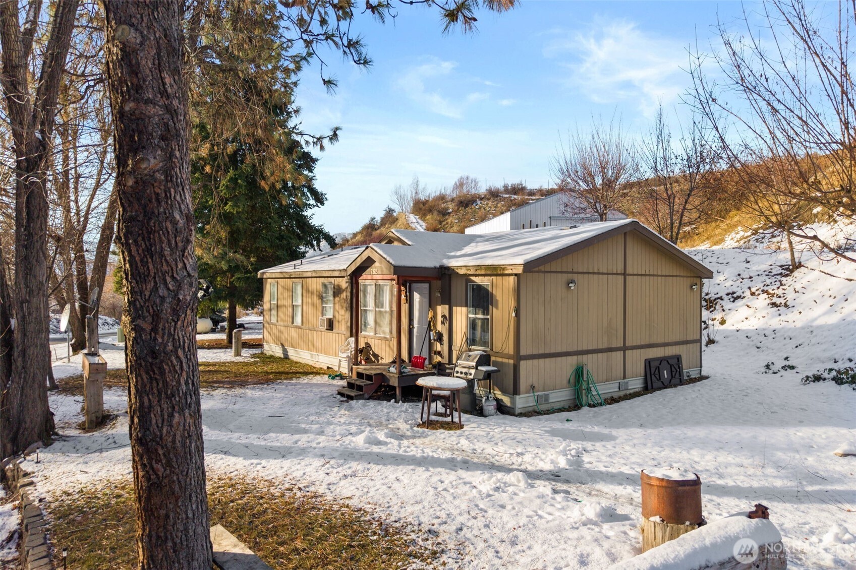 762 Boyd Loop Road Manson, WA 98831 - Photo 2 of 19 a view of a house with wooden fence next to a road