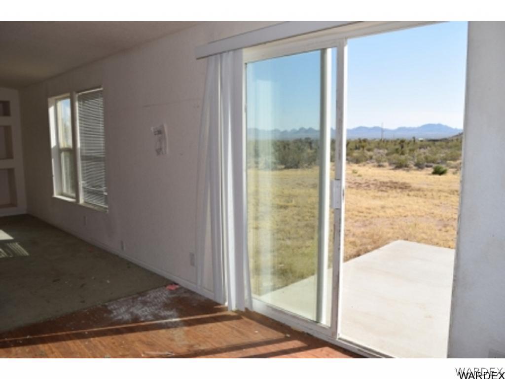 5807 Davis Road Golden Valley, AZ 86413 - Photo 11 of 17 a view of a glass door and a yard from a balcony