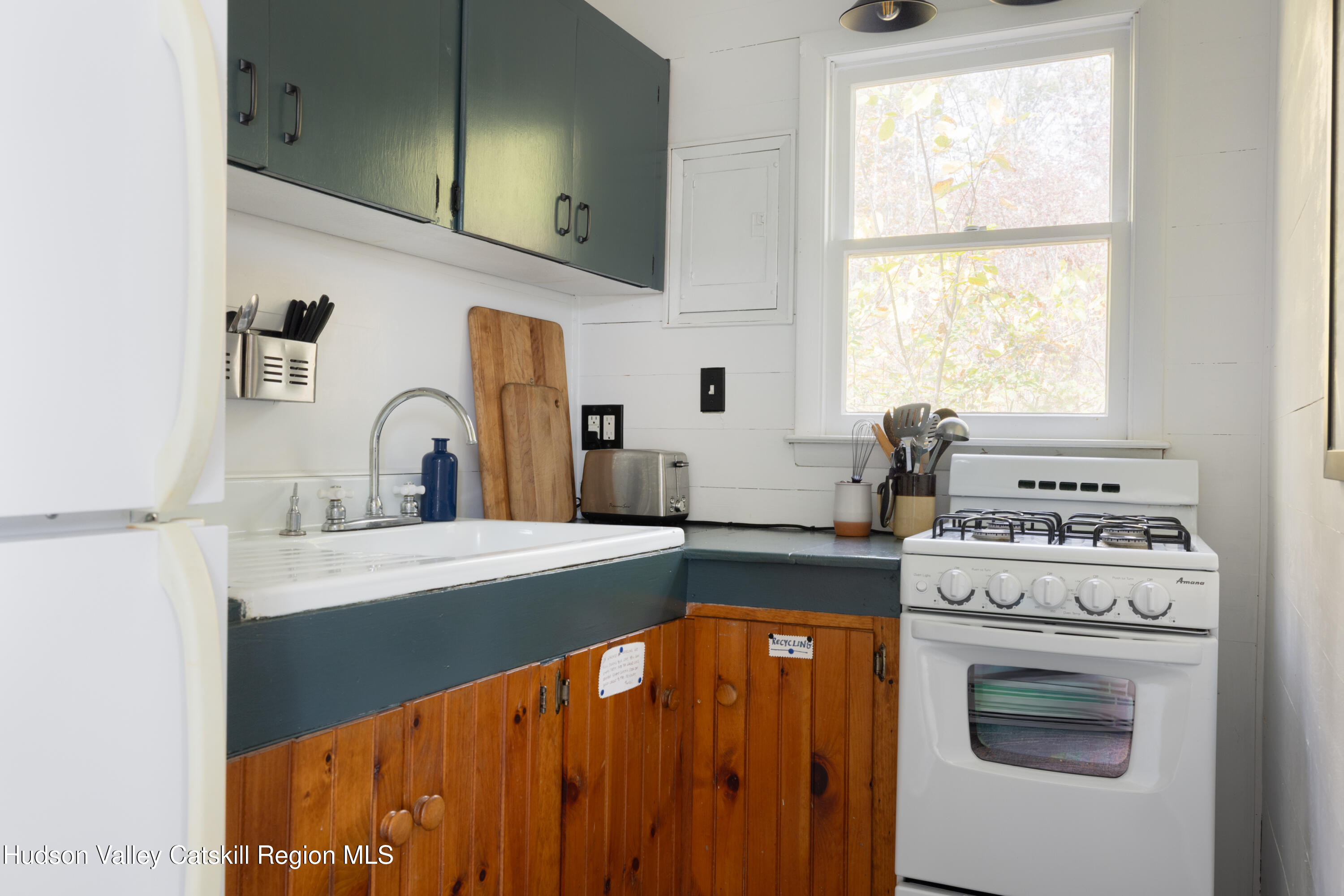 76 Smith Road Preston Hollow, NY 12469 - Photo 39 of 51 a kitchen with a stove a sink and a window