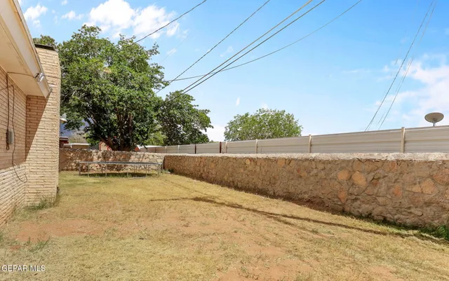 a view of yard with swimming pool and seating area