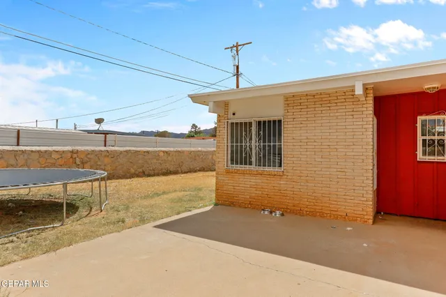 a view of a patio with a table and chairs