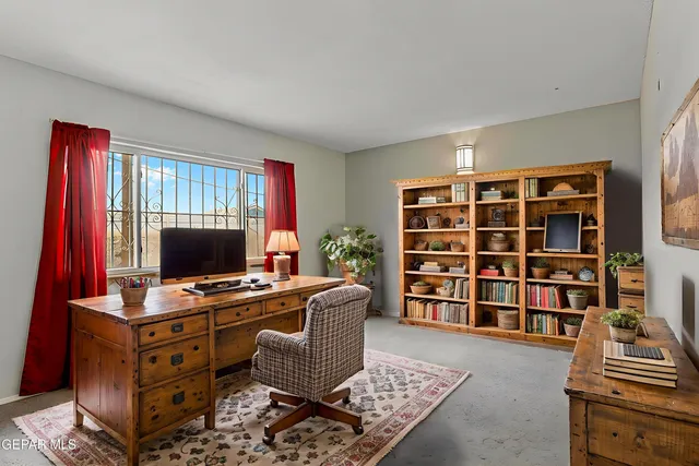a living room with a piano and a bookshelf