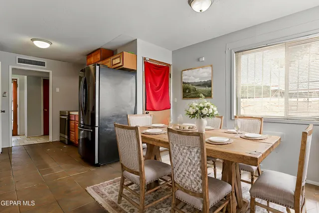 a dining room with furniture and window
