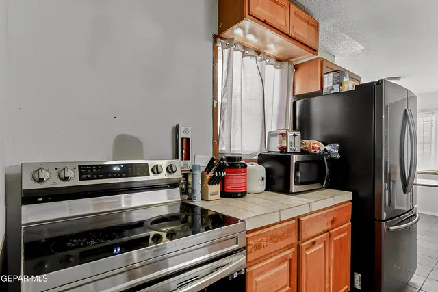 a kitchen with stainless steel appliances a stove and a refrigerator