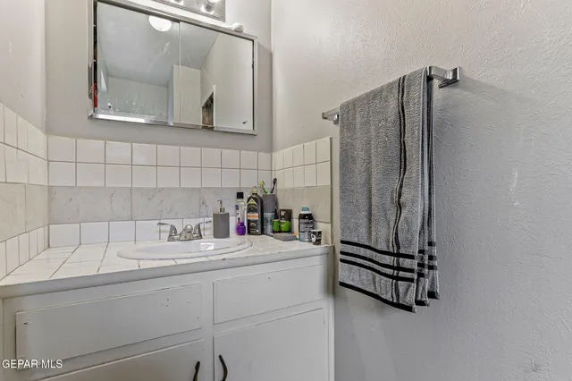 a bathroom with a sink and a mirror