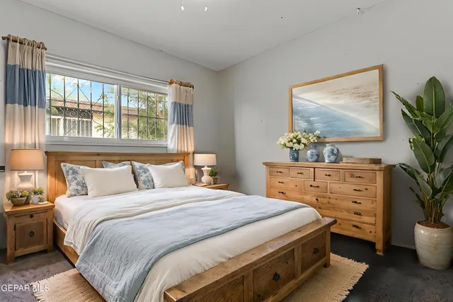 a bedroom with a bed and a painting on the wall