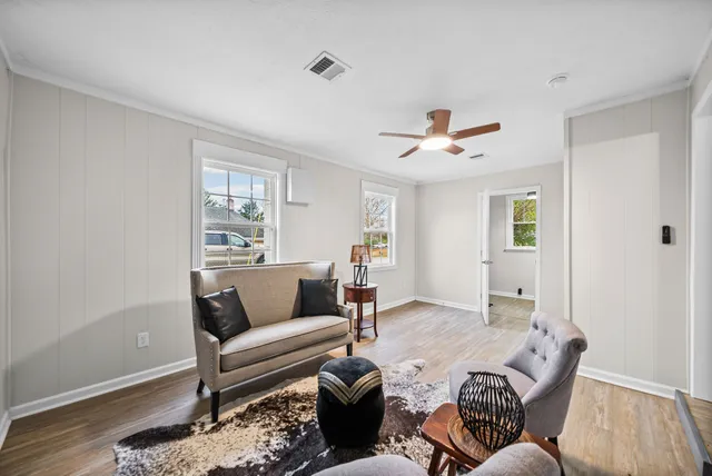 a view of a workspace with furniture and wooden floor