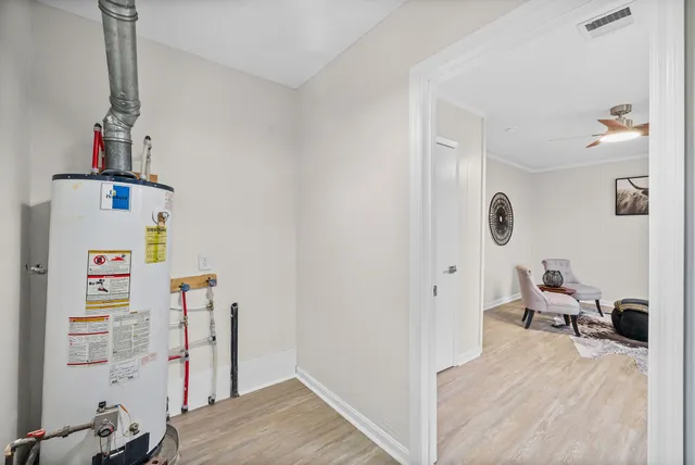 an empty room with a window and a ceiling fan