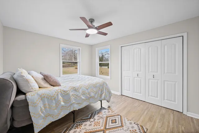 a bedroom with a bed and a ceiling fan