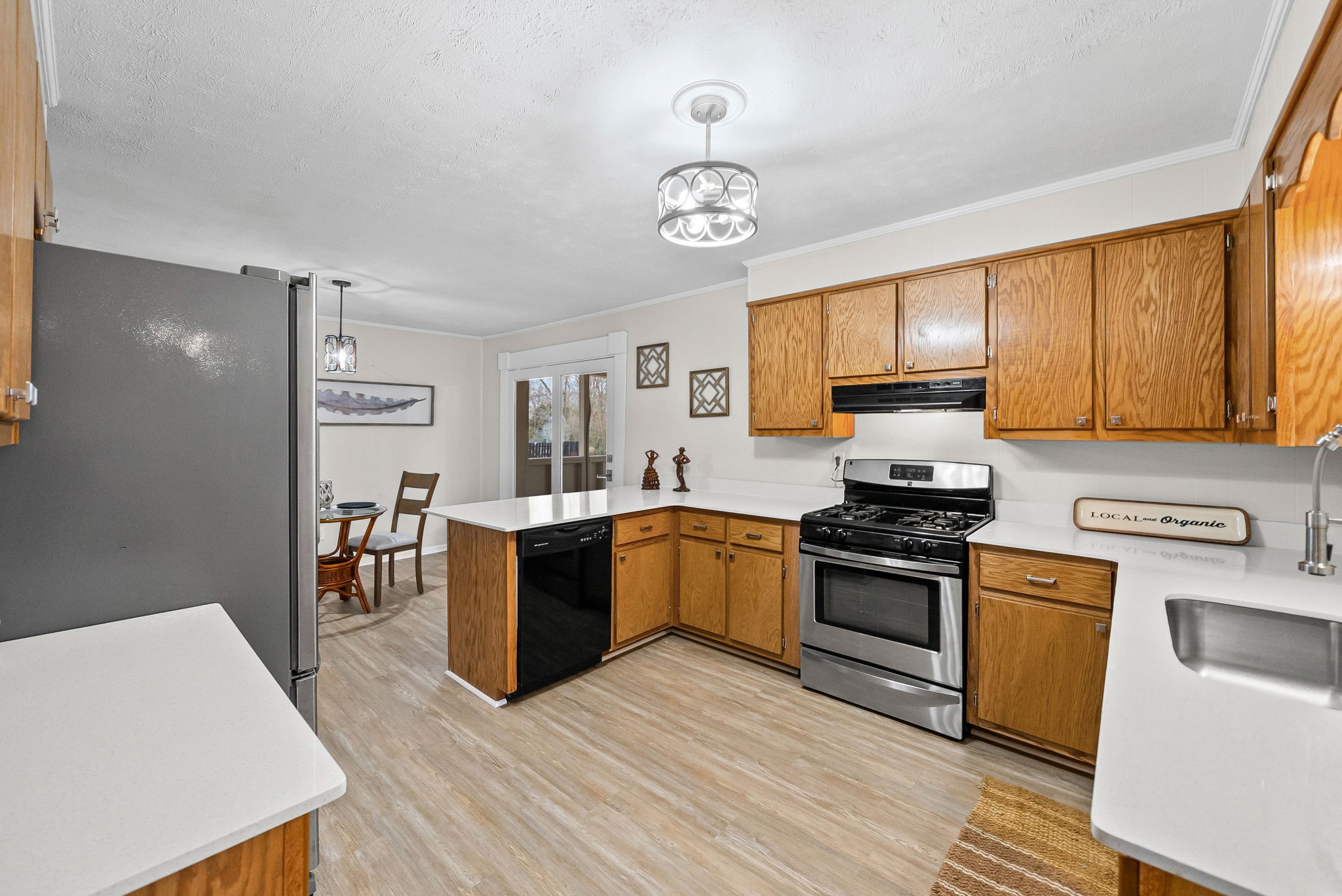 1272 Taylortown Road White Bluff, TN 37187 - Photo 8 of 39 a kitchen with stainless steel appliances granite countertop a refrigerator a stove top oven a sink dishwasher and white cabinets with wooden floor