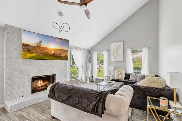 a living room with furniture fireplace and window