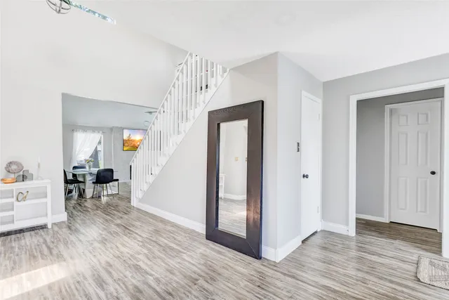 a view of a livingroom with wooden floor and furniture