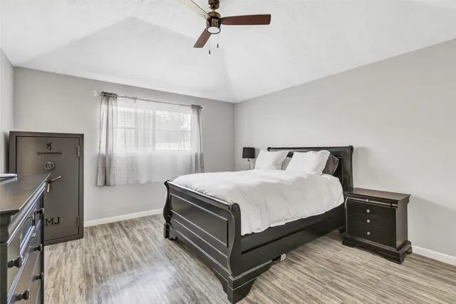 a bedroom with a bed and wooden floor