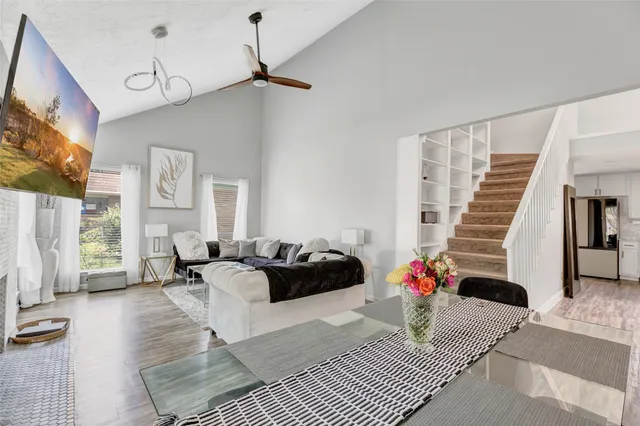 a living room with furniture and wooden floor