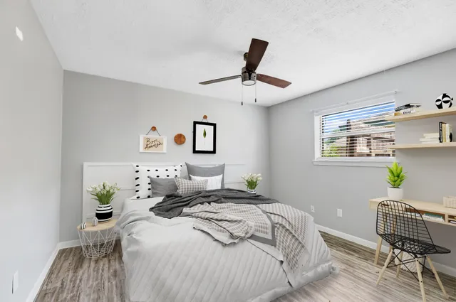 a bedroom with a bed window and couch