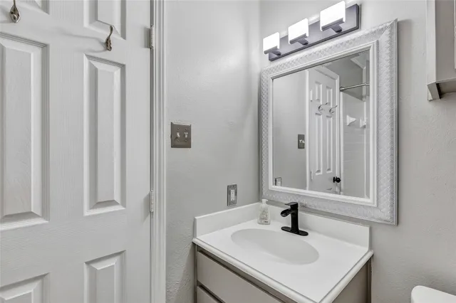 a bathroom with a sink vanity and a mirror