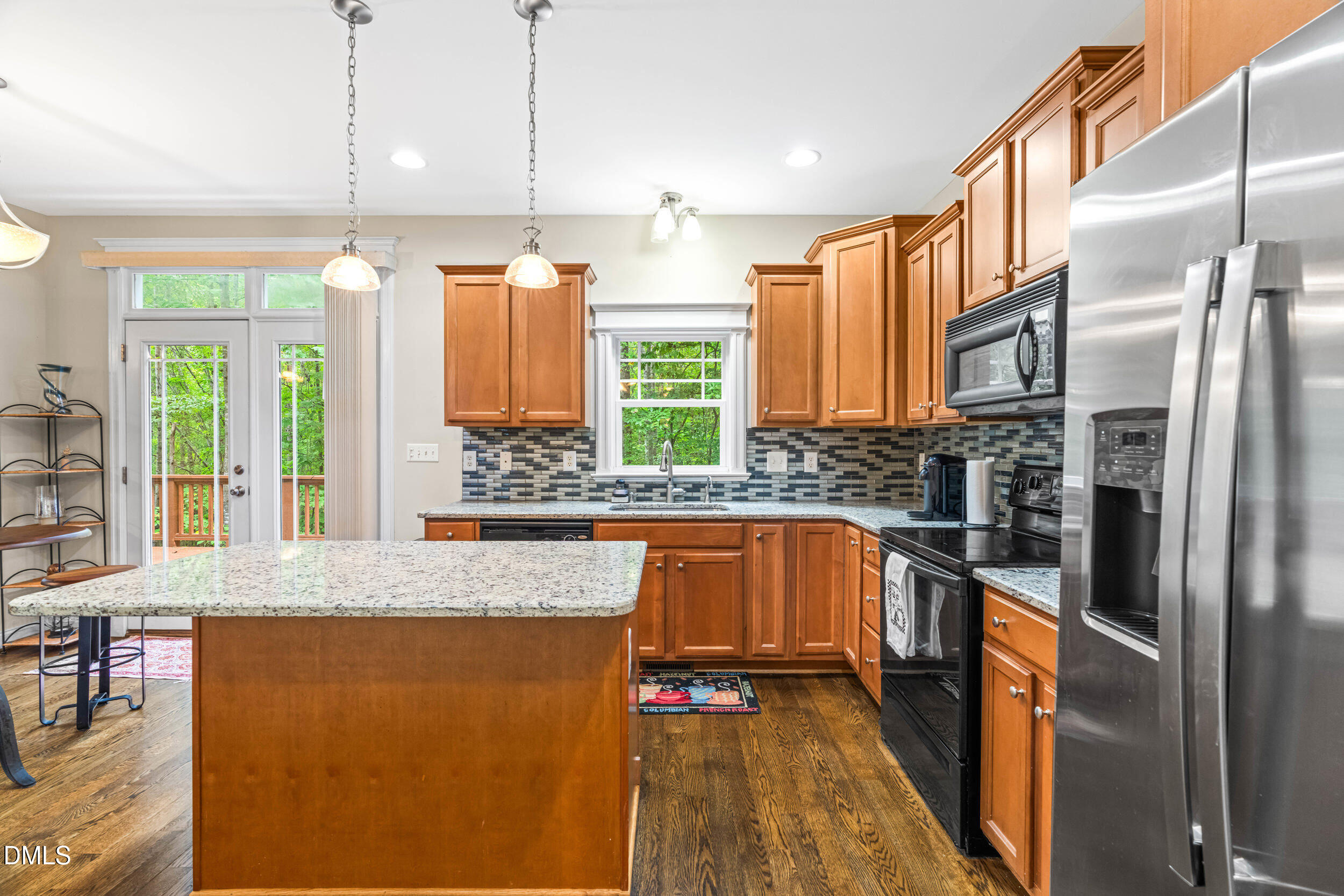 126 Geranium Way Clayton, NC 27527 - Photo 13 of 35 a kitchen with stainless steel appliances granite countertop a refrigerator a stove and a sink