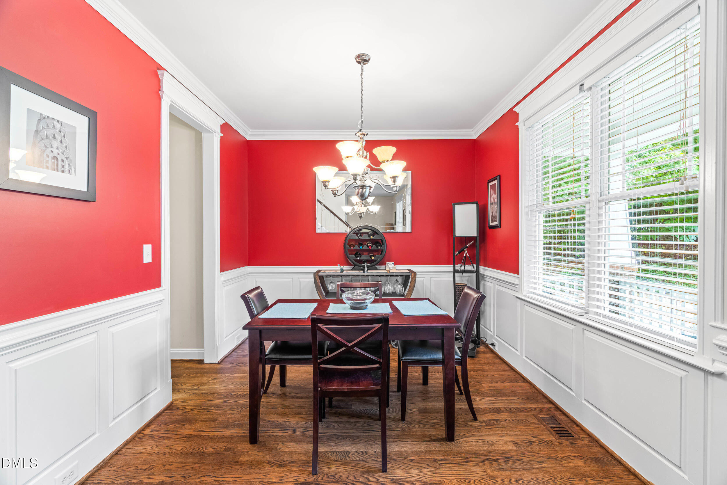 126 Geranium Way Clayton, NC 27527 - Photo 15 of 35 a dining room with furniture a chandelier and wooden floor